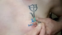 4 needles crossing the tattooed left nipple